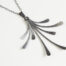 The Flash - Rustic Handmade Fan Necklace in Hammered Iron features 8 gently curving dangling iron elements hammered and faceted to reflect the light. The Flash - Rustic Handmade Fan Necklace in Hammered Iron is a beautifully understated yet striking iron statement necklace. The sterling silver chain matches the cool tones of the Iron perfectly. Light enough for every day, but sophisticated enough for a fancy night out, The Flash - Rustic Handmade Fan Necklace in Hammered Iron is a perfect gift for any occasion. A perfect 6th anniversary gift for her.