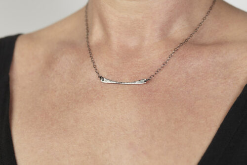 Simple Chic Curved Bar Necklace in Hammered Iron. The handmade, hammered, horizontal curved bar Necklace on a sterling silver chain reflect with lovely contrasting iron tones. Together, the Simple Chic Curved Bar Necklace in Hammered Iron is a simple necklace to wear everyday, or perfect for a fancy night on the town. A perfect iron 6th anniversary gift for her.