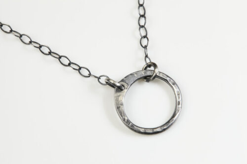 The Simple Zen Circle - Circle Necklace in iron. Featuring a simple hammered iron circle embodying the Japanese concept of Enso, the Simple Zen Circle - Circle Necklace is a beautifully understated yet striking necklace. The hammered iron reflects the cool light in facets creating a lovely and simple everyday necklace. The sterling silver chain matches the bright tones of the iron perfectly. Small and light enough for every day, but sophisticated enough for a fancy night out, The simple Zen Circle - iron Circle Necklace is a perfect gift for every occasion and makes a lovely iron 6th anniversary gift for her