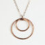 Double Happiness Copper Circle Pendant - two handmade, hammered, concentric circles on a rose gold chain reflecting with a lovely contrasting warm coppery tone on a white background. Copper anniversary gifts for wife