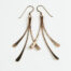 The Mini Flash - Hammered Bronze Earrings displayed laying on a white background, Featuring 3 gently curving dangling bronze elements hammered and faceted to reflect the light. The Mini Flash - Hammered Bronze Earrings are a beautifully understated yet striking pair of statement earrings. The hammered bronze reflects the warm light in facets creating a lovely 8th anniversary gift for her. The gold fill chain matches the warm tones of the bronze perfectly. Light enough for every day, but sophisticated enough for a fancy night out, The mini Flash - Hammered Bronze Earrings are a perfect gift for any occasion. Bronze 8th anniversary gifts