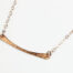 Simple Chic - Horizontal Bar Necklace displayed laying on a white background. The uniquely minimalist copper horizontal bar necklace displays its hand forged textures in the warm light. Rose gold filled chain matches the warm tones of the copper showcasing its simple elegance. Copper anniversary gifts for her