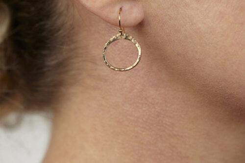 Tiny Zen Circle - Small Hoop Earrings in Bronze displayed nestled together on a white background, these small drop hoop earrings are hand hammered creating a lovely faceted surface that highlights the contrasting light and reflectivity of these simple and beautiful handmade drop hoop earrings. 8th anniversary gifts