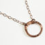 The Tiny Zen Circle - Simple Copper Circle Necklace. Shown on a white background, a simple hammered copper circle embodying the Japanese concept of Enso, the Tiny Zen Circle - Simple Copper Circle Necklace a beautifully understated yet striking necklace. The hammered copper reflects the warm light in facets creating a lovely and simple everyday necklace. The rose gold fill chain matches the warm tones of the copper perfectly. Small and light enough for every day, but sophisticated enough for a fancy night out, The Tiny Zen Circle - Simple Copper Circle Necklace is a perfect gift for every occasion and makes a lovely copper 7th anniversary gift for her