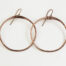The Zen Circle - Copper Large Hoop Earrings. Displayed hanging on a white background, Feature simple hammered copper circles embodying the Japanese concept of Enso, the Zen Circle - Copper Large hoop earrings are beautifully understated yet striking earrings. The hammered copper reflects the warm light in facets creating a lovely and simple everyday earrings. The rose gold fill ear wires matches the warm tones of the copper perfectly. Small and light enough for every day, but sophisticated enough for a fancy night out, The Zen Circle - Copper Large Hoop Earrings are a perfect gift for any occasion. Copper anniversary gifts for her
