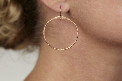The Zen Circle - Copper Hammered Hoop Earrings. Displayed on a white background, Feature simple hammered copper circles embodying the Japanese concept of Enso, the Zen Circle - Copper hammered hoop earrings are beautifully understated yet striking earrings. The hammered copper reflects the warm light in facets creating a lovely and simple everyday earrings. The rose gold fill ear wires matche the warm tones of the copper perfectly. Small and light enough for every day, but sophisticated enough for a fancy night out, The Zen Circle - Copper Hammered Hoop Earrings are a perfect gift for any occasion. copper anniversary gifts