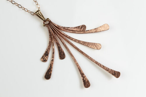 flash - hammered copper statement necklace diagonal front view of the delicate chain and 8 slightly curving hammered copper elements reflecting the light. Copper 7th anniversary gifts for wife