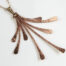 flash - hammered copper statement necklace diagonal front view of the delicate chain and 8 slightly curving hammered copper elements reflecting the light. Copper 7th anniversary gifts for wife