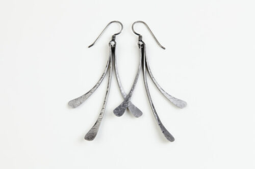 The Mini Flash - long dangle Earrings in hammered iron feature 3 gently curving dangling iron elements hammered and faceted to reflect the light. The Mini Flash - long dangle earrings are beautifully understated yet striking iron statement earrings. The sterling silver chain matches the iron perfectly. Light enough for every day, but sophisticated enough for a fancy night out, The Mini Flash - Long Dangle Earrings in hammered iron are a perfect 6th anniversary gift.