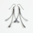 The Mini Flash - long dangle Earrings in hammered iron feature 3 gently curving dangling iron elements hammered and faceted to reflect the light. The Mini Flash - long dangle earrings are beautifully understated yet striking iron statement earrings. The sterling silver chain matches the iron perfectly. Light enough for every day, but sophisticated enough for a fancy night out, The Mini Flash - Long Dangle Earrings in hammered iron are a perfect 6th anniversary gift.