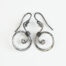 The Tiny Swirls - Spiral Hoop Earrings in Iron. These iron drop hoop spiral earrings have a wire wrapped iron detail that creates the closed circle of the hoop creating a tiny spiral inside the hoops that provide the cute focal point of the earrings. Delicately hammered facets reflect the light of the hammered iron. The sterling silver ear wires match the polished iron perfectly. Small and light enough for every day, but sophisticated enough for a fancy night out, the Tiny Swirls - Spiral Hoop Earrings in iron are perfect for every occasion and make a lovely 6th anniversary gift for her