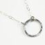 The Tiny Zen Circle - Aluminum Simple Circle Necklace. Shown on a white background, a simple hammered Aluminum circle embodying the Japanese concept of Enso, the Tiny Zen Circle - Aluminum Simple Circle Necklace a beautifully understated yet striking minimalist necklace. The hammered Aluminum reflects the cool light in facets creating a lovely and simple everyday necklace. The sterling silver chain matches the aluminum perfectly. Small and light enough for every day, but sophisticated enough for a fancy night out, The Tiny Zen Circle - Aluminum Simple Circle Necklace is a perfect gift for every occasion and makes a lovely Aluminum anniversary gift for her