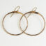 The Zen Circle - Chunky Hoops Bronze Earrings. Displayed on a white background, Feature simple hammered bronze circles embodying the Japanese concept of Enso, the Zen Circle - bronze hammered hoop earrings are beautifully understated yet striking earrings. The hammered bronze reflects the warm light in facets creating a lovely and simple everyday earrings. The gold fill ear wires match the warm tones of the bronze perfectly. Small and light enough for every day, but sophisticated enough for a fancy night out, The Zen Circle - Chunky Hoops Bronze Earrings are a perfect gift for any occasion. Bronze 8th anniversary gifts